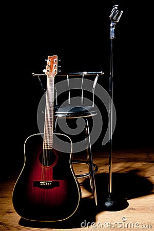 Retro microphone, stool and guitar Stock Photo