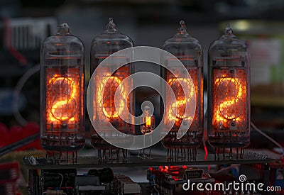 Retro Nixie lamp indicator clock on dark background 2022 number Stock Photo