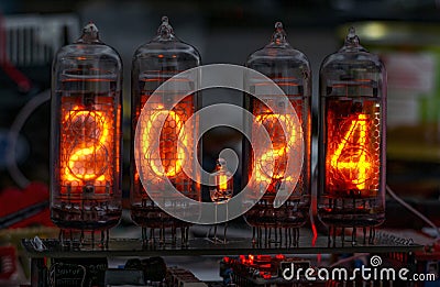 retro Nixie lamp indicator clock on dark background 2024 number Stock Photo