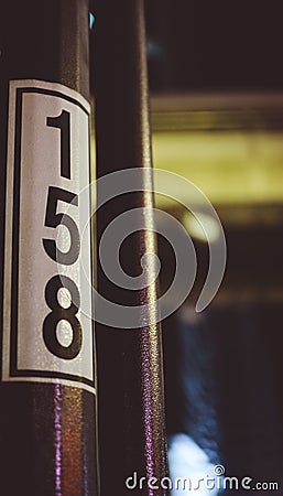 Retro number of 158 on a poll at night Stock Photo