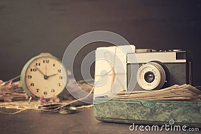 Retro old camera with pile of photos, letters, malachite box and antique watches on wooden background. Memories, nostalgia, Stock Photo