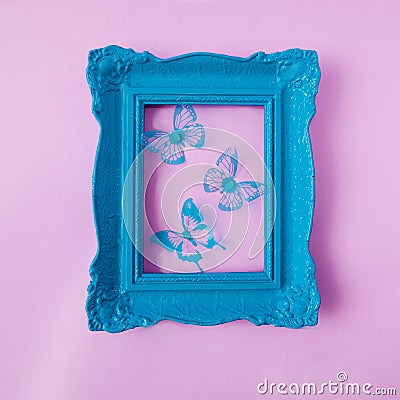 A retro old fashionned pastel blue frame with blue butterflies against pastel pink background. Romantic spring summer design for Stock Photo