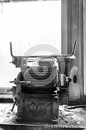 Retro old rusty electric motor. Window light. Black and White. Stock Photo