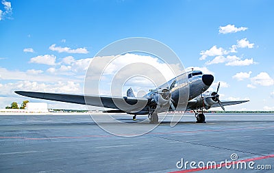 Retro passenger plane on the runway. sunny summer day with clouds Stock Photo