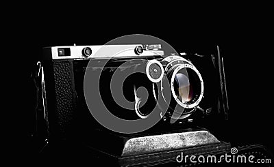 Retro photo camera close up on the black background Stock Photo