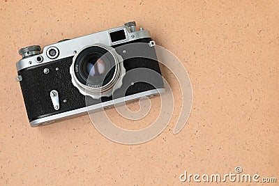 Retro photo camera on old vintage paper with texture and copyspace, top view, retro things concept Stock Photo