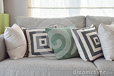 Retro pillows on cozy grey sofa in the living room Stock Photo