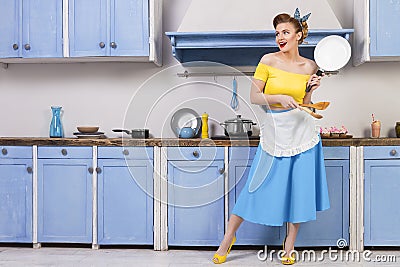 Retro pin up girl housewife in the kitchen Stock Photo