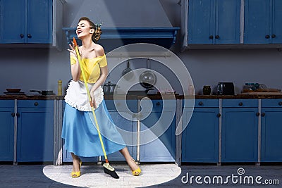 Retro pin up woman holding mop singing and cleaning Stock Photo