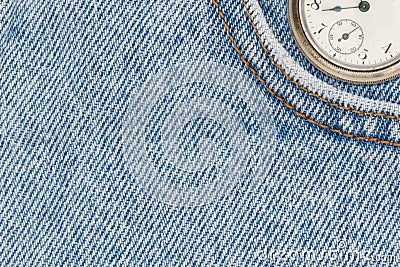 Retro pocket watch with blue jeans denim material Stock Photo