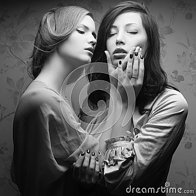 Retro portrait of two gorgeous women (girlfriends) kissing Stock Photo