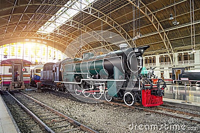 Retro steam train arrived from the arch railway station. Editorial Stock Photo