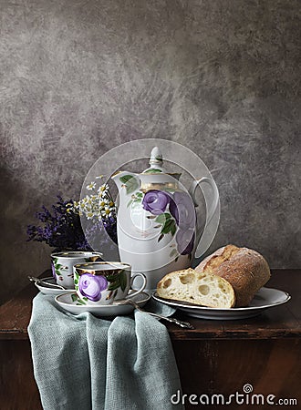 Retro still life poster breakfast. Vintage coffee pot kettle cups, silver spoon, homemade bread bakery. Dark light Stock Photo