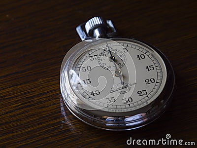 Retro stopwatch is on a wooden table Stock Photo