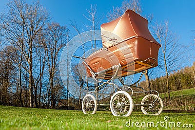 Retro style baby carriage outdoors on sunny day Stock Photo