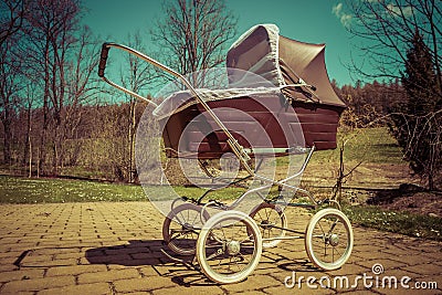 Retro style baby carriage outdoors on sunny day Stock Photo