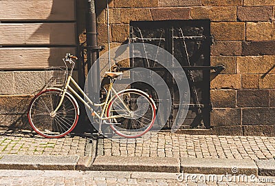 A retro style bicycle changed to a pole, in the old townGamla Stan of Stockholm, Sweden. Stock Photo