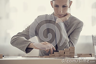 Retro style image of a businesswoman building a ladder of success Stock Photo