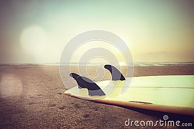 surfboard on beach at sunset Stock Photo