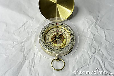 Retro styled golden compass Vintage still life. Sailing accessories. Travel, navigation, history, collecting, hobby Stock Photo