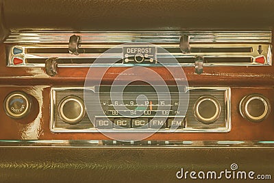 Retro styled image of an old dashboard with seventies car radio Stock Photo