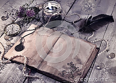 Retro styled still life with old diary, black candle and mystic objects Stock Photo