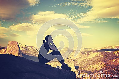 Retro stylized silhouette of a woman watching mountain view. Stock Photo