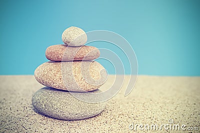 Retro stylized stone pyramid on sand, harmony and balance concept Stock Photo