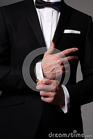 Retro suit fashion. Formal classic suit. Business style outfit. Handsome businessman adjusting his sleeves. Stock Photo