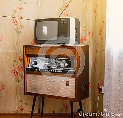 Retro technology, vintage radiogram 1960s and tube tv at home in living room, old school style 1970s Editorial Stock Photo