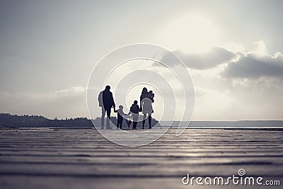 Retro toned image of family with mother, father, two kids and a Stock Photo