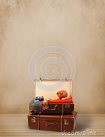 Retro tourist luggage with colorful clothes and copyspace Stock Photo