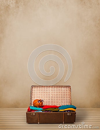 Retro tourist luggage with colorful clothes and copyspace Stock Photo