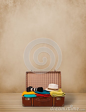 Retro tourist luggage with colorful clothes and copyspace Stock Photo