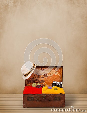 Retro tourist luggage with colorful clothes and copyspace Stock Photo