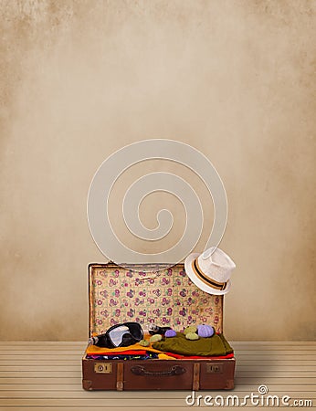 Retro tourist luggage with colorful clothes and copyspace Stock Photo