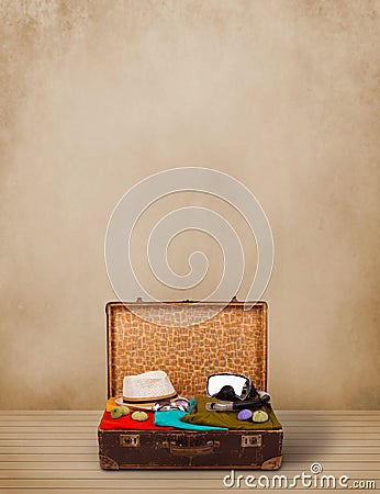 Retro tourist luggage with colorful clothes and copyspace Stock Photo