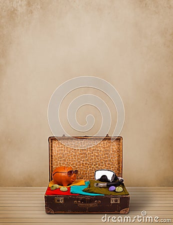 Retro tourist luggage with colorful clothes and copyspace Stock Photo