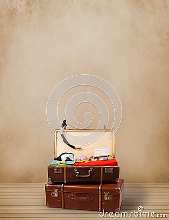 Retro tourist luggage with colorful clothes and copyspace Stock Photo