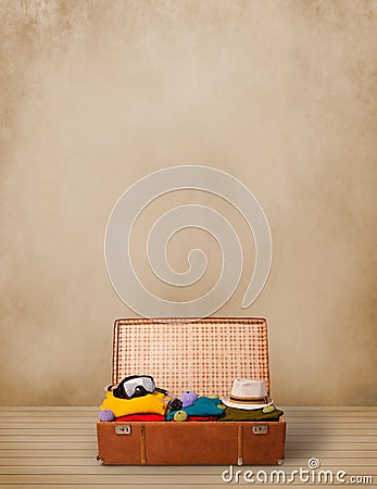 Retro tourist luggage with colorful clothes and copyspace Stock Photo