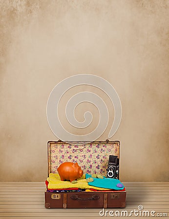 Retro tourist luggage with colorful clothes and copyspace Stock Photo