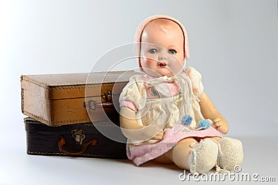 Retro toys, vintage doll and old suitcases Stock Photo