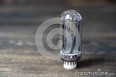 Retro vacuum lamp on a wooden background, close up Stock Photo