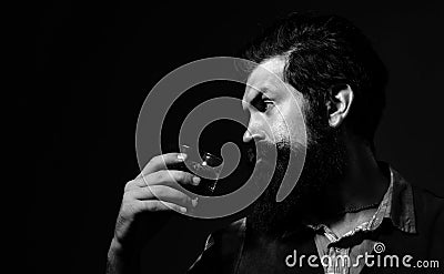 Retro vintage man with whiskey or scotch. Fashionable man in white shirt and suspenders. Bearded and glass of whiskey. Stock Photo