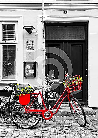 Retro vintage red bicycle on cobblestone street in the old town. Stock Photo