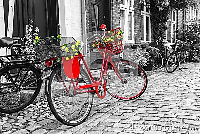 Retro vintage red bicycle on cobblestone street in the old town. Stock Photo