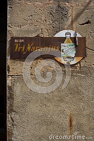 Retro vintage soda drink ad on textured grungy stone wall Editorial Stock Photo