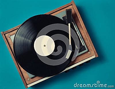 Retro vinyl player on a blue background. Entertainment 70s. Listen to music. Stock Photo