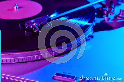 Retro wave, 80s. Record player with neon light. Vinyl analog turntable. Synthwave and vaporwave concept Stock Photo