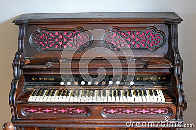 Western Cottage Antique Organ with Pink and Brown Editorial Stock Photo